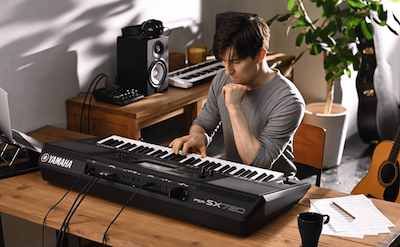 Photo of a person playing Yamaha Arranger Workstation PSR-SX720